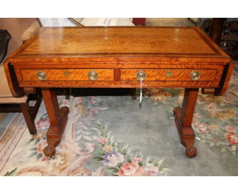 A Regency period satinwood, mahogany banded, veneered sofa table, fitted with two short drawers, raised on square pedestal su