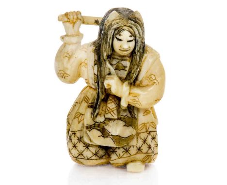 A 19th century Japanese carved ivory netsuke, in the form of a woman combing her hair, signed