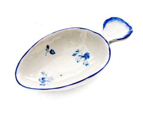 A Derby porcelain caddy spoon, circa 1780, egg form with shell moulded handle, feather edged, decorated with blue flroal spra