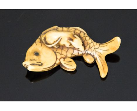 An Oriental ivory netsuke, carved as a rat on a carp, width 5cm (s.d)