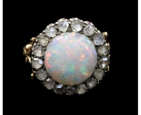 A Victorian opal and diamond ring, with round cabachon opal to the centre displaying orange, red, green and purple fire, appr