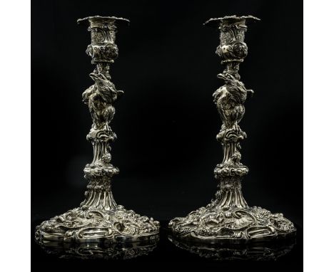 A pair of George IV Empire silver candlesticks, heavily cast in the Chinoiserie Rococo style, each candlestick with a golden 