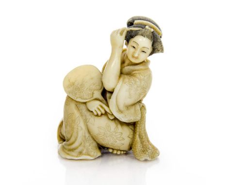 A 19th century Japanese carved ivory netsuke, in the form of a Geisha, with mirror, signed