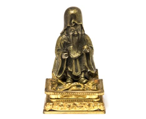 A Japanese bronze miniature model of Hotei, modelled standing and wearing a patterned robe, signed, height 8cm, on a gilt woo