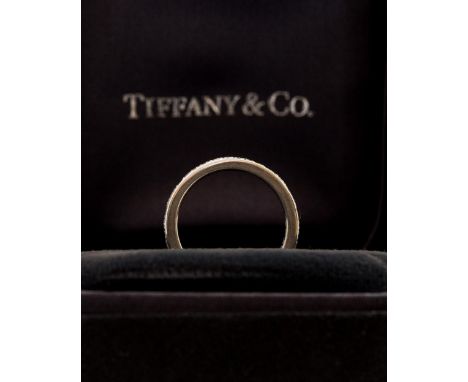 A Tiffany & Co diamond full eternity platinum ring, Tiffany marks to inside shank, ring size K 1/2, in original box and carto