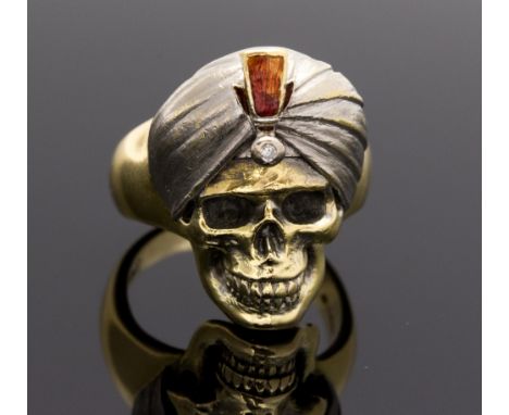 A Theo Fennel 18ct white and yellow gold skull ring, with turban highlighted in red enamel with a single diamond, stamped wit