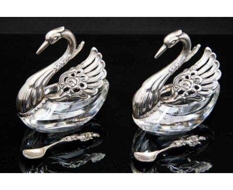 A pair of glass silver mounted swan condiments with articulated plumage, with two spoons (4)