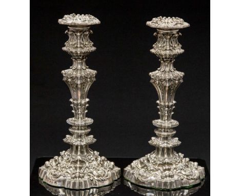 A pair of Victorian silver candlesticks, heavily cast in high relief with floral and foliate scroll decoration, weighted, Wil