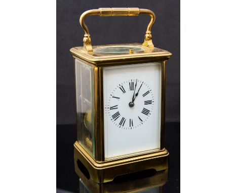 A French brass repeating carriage clock, early 20th Century, corniche case, white enamel Roman dial, gong striking mechanism,