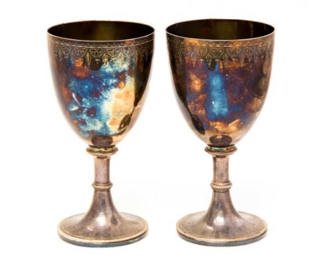 A pair of large Victorian silver goblets, bead knopped stems and feet, with bright cut engraving in the Neoclassical style, t