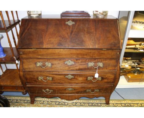 A late 18th Century mahogany bombe bureau, probably Dutch, the fall front enclosing a fitted interior of drawers and pigeon h