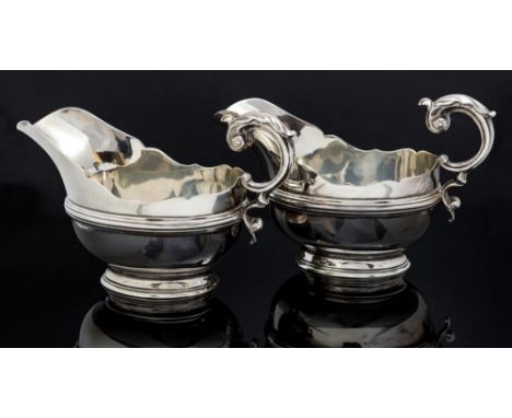 A pair of George VI silver sauce boats, helmet shape, scroll handles, maker Jay, Richard Attenborough Co Ltd, Sheffield 1938,