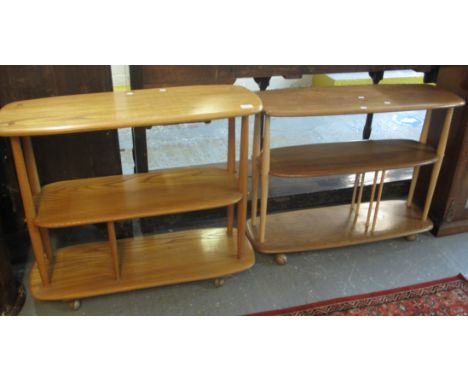 Two similar Ercol light elm three tier whatnots with shaped shelves. Unmarked. (2) (B.P. 24% incl. VAT)Condition report: Some