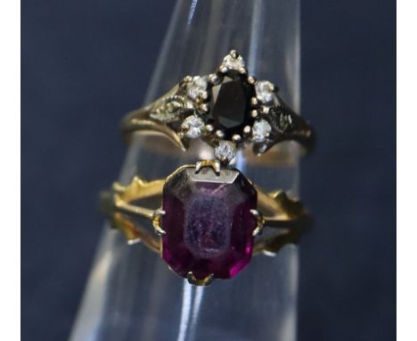 Two 9ct rings, one set with a purple stone with pierced shoulders. Weight 2.4g approx, ring size K 1/2. The other sapphire an