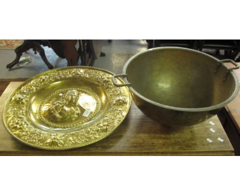 Beaten brass circular two handled bowl, together with a brass repousse portrait charger. (2)(B.P. 24% incl. VAT) 