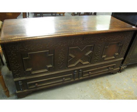Large heavy oak coffer having moulded hinged top above carved indented foliate decoration, with three moulded and fielded pan