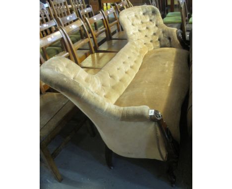 Victorian upholstered button back double ended sofa on a mahogany frame with serpentine front, standing on carved scrolled ca