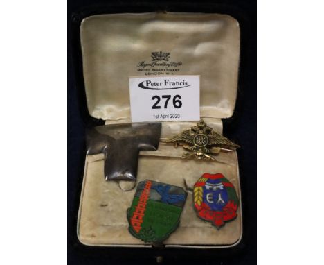 Two enamel pin brooches, Vietnam etc, together with a brass double eagle pin brooch and a silver T shaped pin brooch, cased. 