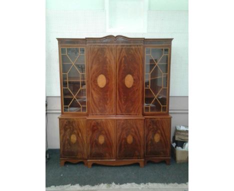 of breakfront rectangular form, the shaped cornice resting on a pair of inlaid panel doors enclosing a mirror back bar unit f