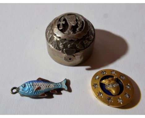 decorated with Egyptian figure, together with a small enamel fish charm and another similar item
