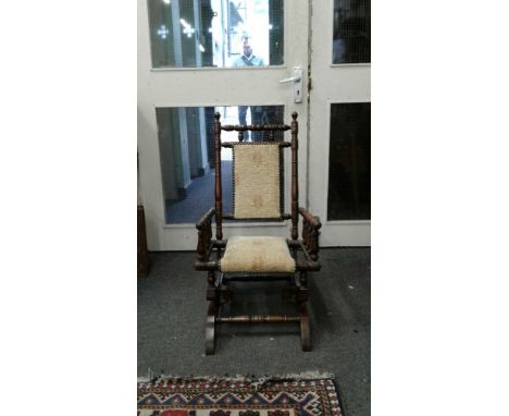 the turned mahogany frame with upholstered back panel