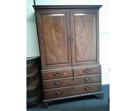 the upper section enclosed by pair of panel doors opening to reveal a shelved interior seated on a chest of two short and two
