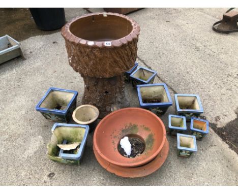 A PLANTER ON MATCHING STAND IN THE FORM OF A TREE TRUNK TOGETHER WITH VARIOUS OTHER PLANT POTS.