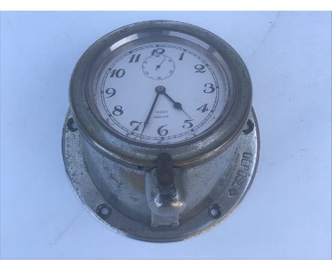 A Doxa Automobile car clock on sloping mount for a low down dashboard, to suit an Edwardian motor car.