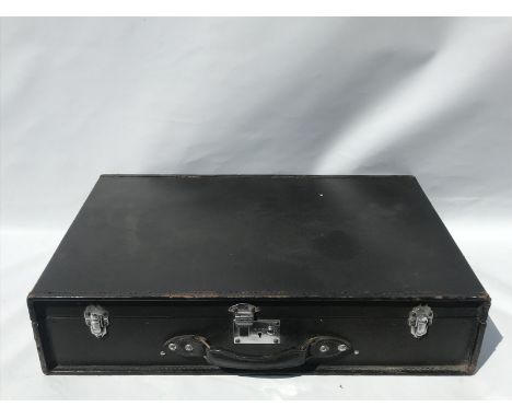A rectangular car trunk with chrome plated catches.