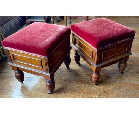 A pair of Victorian oak stools, hinged stuffed over seats, panelled sides, turned legs, on casters, 50cm high, 37cm wide, c.1
