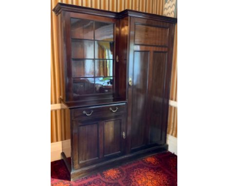 An early 20th century mahogany hall cupboard, the breakcentre cornice, astragal glazed door, above drawer and field cupboard 