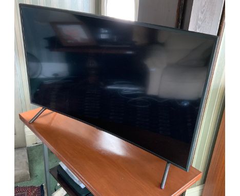 A Samsung television and remote control, curved 48in screen, model code UE49RU7300KXXU,;  a Samsung DVD player** We would ple