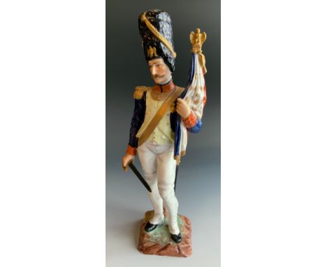 A Naples Capo-di-Monte Military figure, of a Napoleonic standard bearer, Garde-Drapeau des Grenadiers, 28cm high,  titled gil