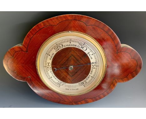 An  early 20th century barometer, inscribed Baxendale & Co Ltd, Manchester, quatrefoil shaped quarter veneered back, 32cm x 4