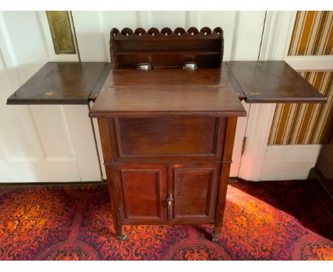 An unusual early 20th century mahogany lady's writing/dressing table, the folding rectangular top opening and lifting a two t