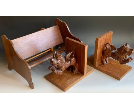 An early 20th century mahogany book rest, 43cm wide, c.1910;  another, contemporary;  a pair of Balinese bookends, carved wit