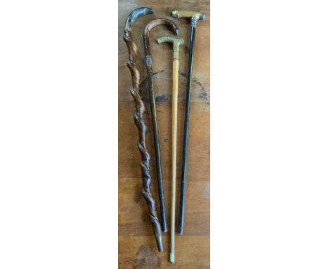 A rustic stick, horn handle, wrythen stem, 87cm long;  another, silver mounted, ebony shaft, cm long;  others (4)** We would 