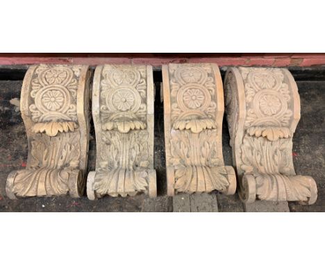 A set of four 'terracotta' baroque style corbels, decorated with floral roundels and acanthus leaves; three terracotta ridge 