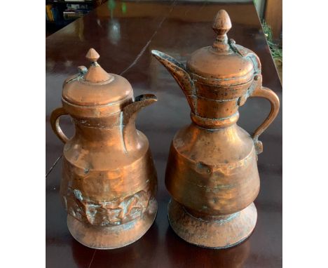 A 19th century Persian copper coffee pot, of typical, hinged cover, 38cm high'  another, 33cm high (2)** We would please ask 