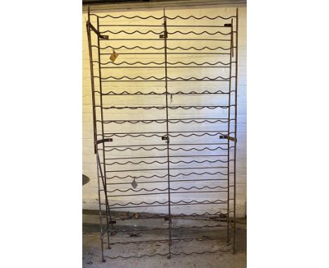 A wrought iron country house wine rack, for up to 180 bottles, approximately 180cm high, 100cm wide.** We would please ask th