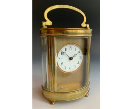 A French brass oval carriage clock, Roman numerals, swing handle, 11cm high** We would please ask that all payments are made 