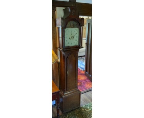 A 19th century oak longcase clock, mahogany crrossbanded the arched dial painted with country couple, Roman numerals, twin wi