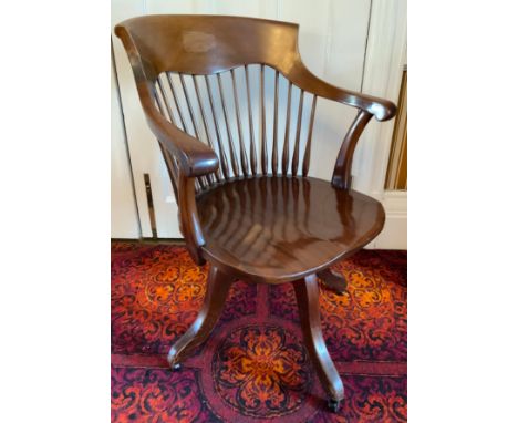 An early 20th century mahogany office swivel chair, spindle back, shaped seat, four splayed legs, fitted casters, c.1920** We