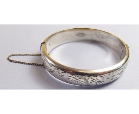 A silver engraved bangle boxed