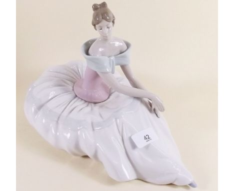 A large Nao figure of a seated girl 23 x 33cm