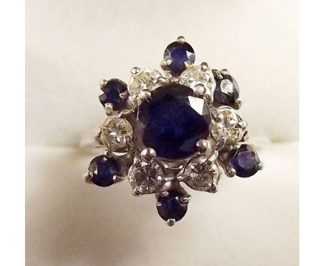 An 18 carat white gold sapphire and diamond cluster ring, size K