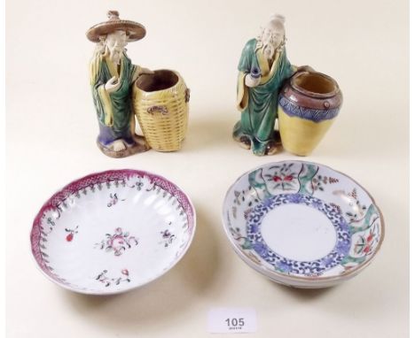 Two Japanese pottery figures and two Chinese saucers