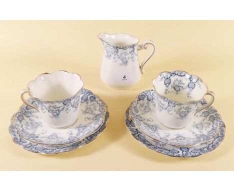 An Edwardian blue floral tea service comprising six cups and saucers, twelve tea plates and milk jug