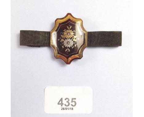 A Victorian ribbon bracelet with tortoiseshell panel inlaid  gold and silver flowers
