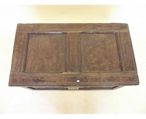 An 18th century oak two panel coffer with lunette carved frieze over scrollwork panels, all on stile supports - 85cm wide